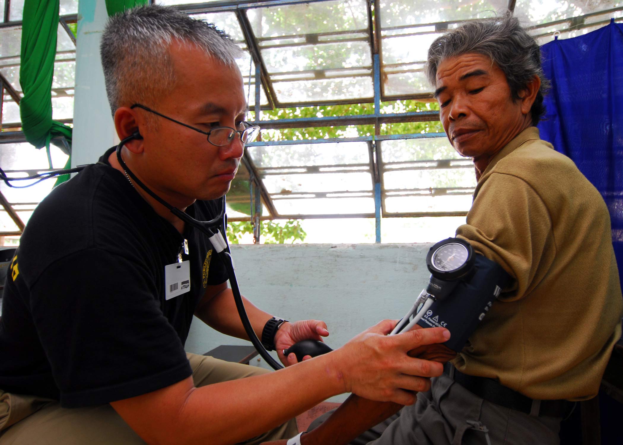 Image of person getting his blood pressure checked by a manual BP monitoring device