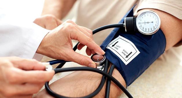 Image of doctor checking a patient’s blood pressure manually