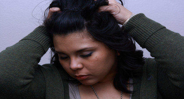 Image of girl trying to relieve headache