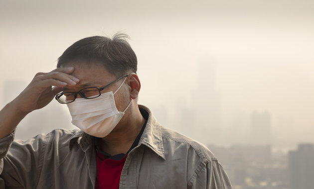 Image of a person suffering in a polluted city