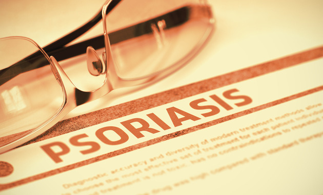Image of a newspaper article on Psoriasis on newspaper with spectacles on it.