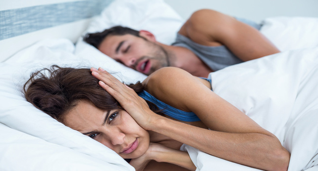 Image of a woman irritated of her partner’s snoring habits