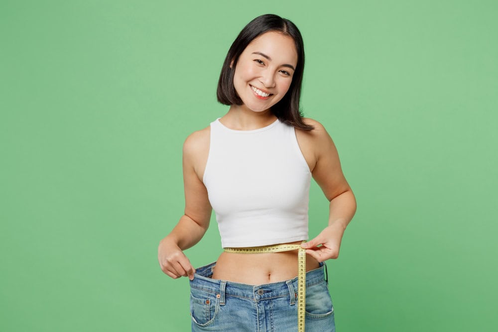 Young,Woman,Wear,White,Clothes,Show,Loose,Pants,After,Weightloss