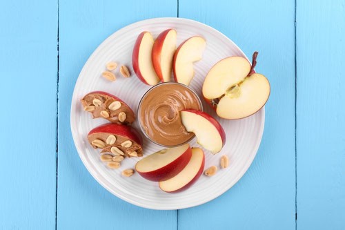 Fresh,Red,Apple,With,Peanut,Butter,And,Nuts,On,Light