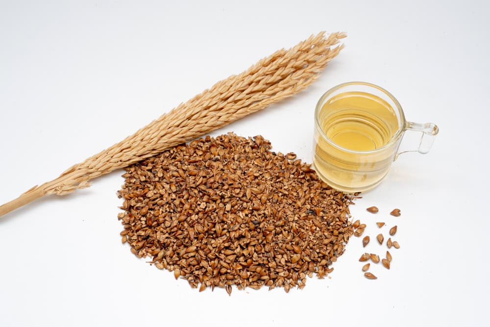 Barley,Tea,Seeds,Rice,Ears,And,Wooden,Spoon,On,White